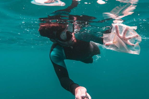 Diver collecting plastic underwater