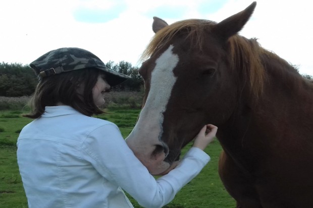 Young adult connecting with a horse