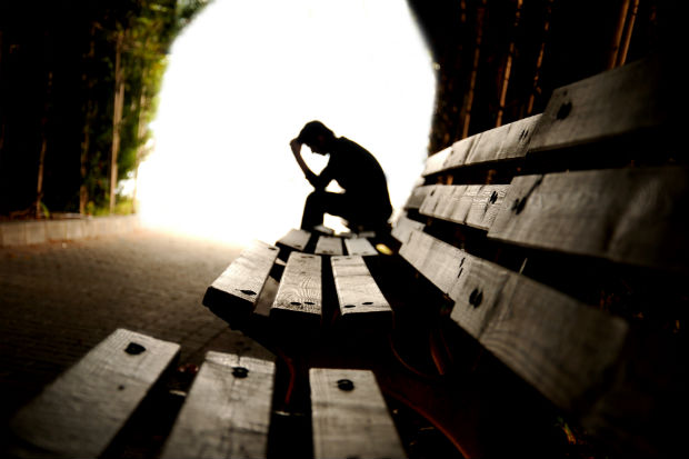 Photo of a man sitting on a bench