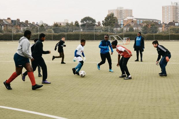 Group of young children participating in football training